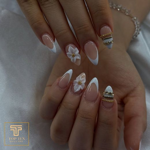 Almond French tips with 3D flowers and gold charms, nails by Jay at Top Ten Nails Spa