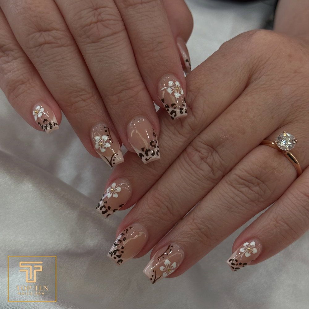Leopard print and white flower nail design, nails by Zoey at Top Ten Nails Spa